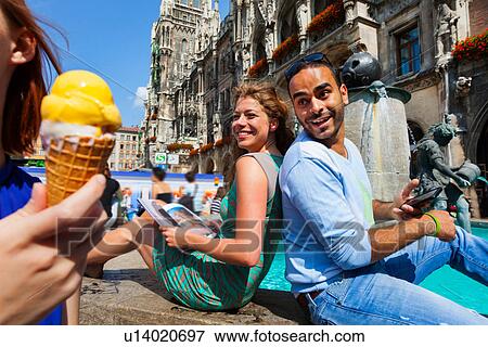 Couple and woman with ice cream, Munich Marienplatz, Munich, Germany View Large Photo Image Stock Photo - Couple and woman with ice cream, Munich Marienplatz, Munich, Germany. Fotosearch