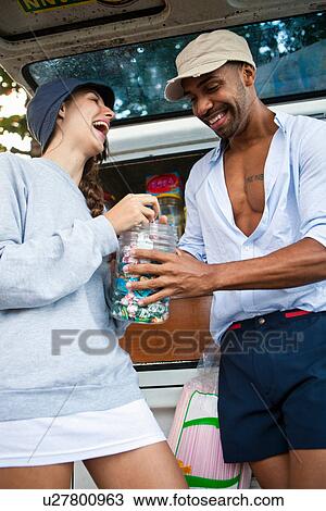 Couple by campervan with candy jar View Large Photo Image Stock Image - Couple by campervan with candy jar. Fotosearch