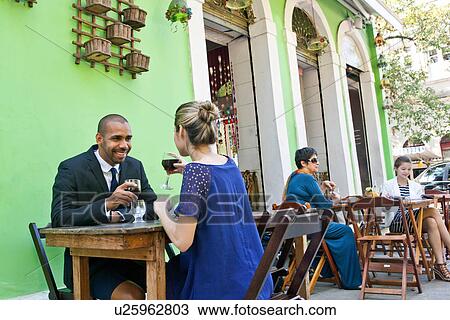 Couple having wine outside cafe View Large Photo Image Stock Image - Couple having wine outside cafe. Fotosearch