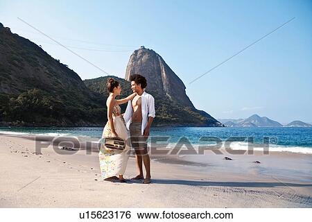 Couple on beach with radio, Rio de Janeiro, Brazil View Large Photo Image Stock Photograph - Couple on beach with radio, Rio de Janeiro, Brazil. Fotosearch