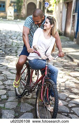 Couple on bicycle, Rio de Janeiro, Brazil View Large Photo Image Stock Photo - Couple on bicycle, Rio de Janeiro, Brazil. Fotosearch