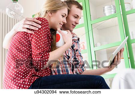 Picture - Couple on video chat using digital tablet. Fotosearch