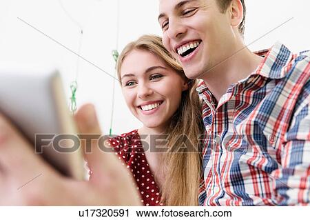 Stock Image - Couple on video chat using digital tablet. Fotosearch