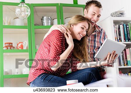 Couple on video chat using digital tablet View Large Photo Image Stock Image - Couple on video chat using digital tablet. Fotosearch