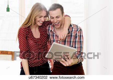 Couple on video chat using digital tablet View Large Photo Image Stock Image - Couple on video chat using digital tablet. Fotosearch