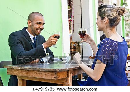 Couple outside cafe, toasting with wine View Large Photo Image Stock Photography - Couple outside cafe, toasting with wine. Fotosearch