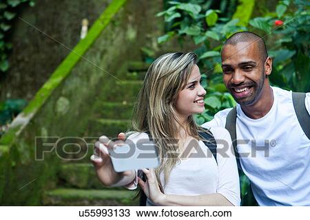 Couple photographing themselves in jungle View Large Photo Image Stock Image - Couple photographing themselves in jungle. Fotosearch