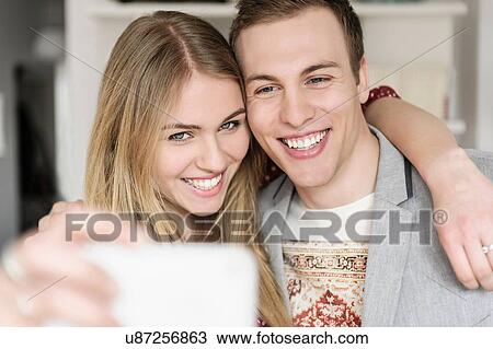 Stock Image - Couple self-photographing. Fotosearch