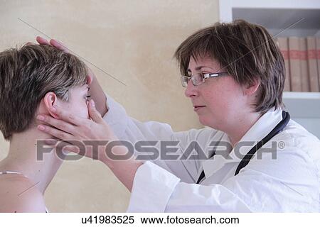 Doctor examining woman's face View Large Photo Image Stock Photography - Doctor examining woman's face. Fotosearch