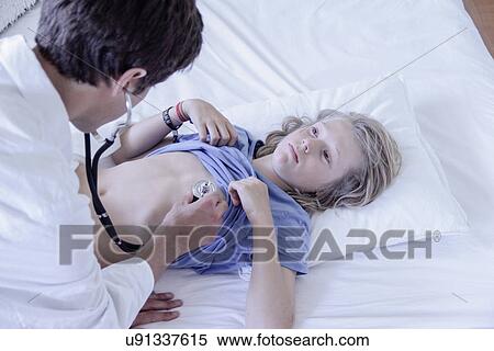Doctor using stethoscope on boy View Large Photo Image Stock Photography - Doctor using stethoscope on boy. Fotosearch