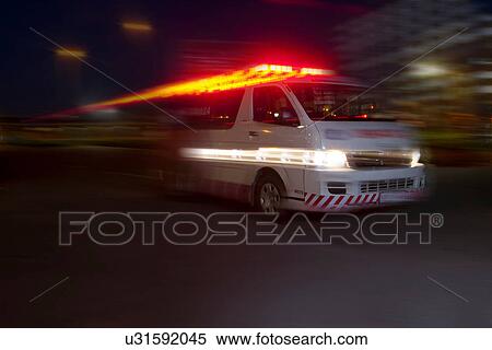 Emergency ambulance speeding through city at night View Large Photo Image Stock Photography - Emergency ambulance speeding through city at night. Fotosearch