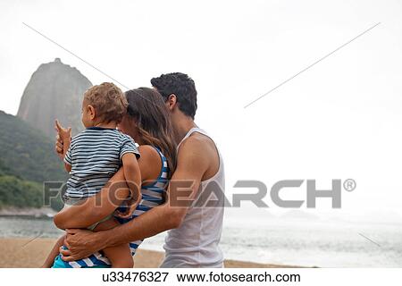 Stock Photo - Family on beach with Sugarloaf Mountain, Rio de Janeiro, Brazil. Fotosearch