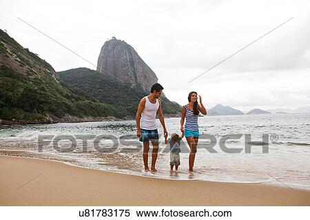Stock Photography - Family walking on beach holding hands, Rio de Janeiro, Brazil. Fotosearch