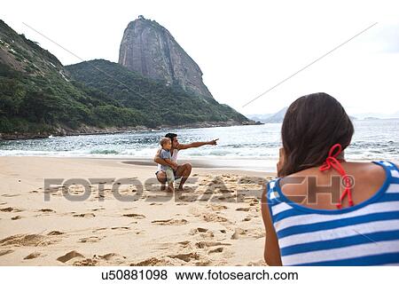 Stock Photo - Father and son on beach, Rio de Janeiro, Brazil. Fotosearch