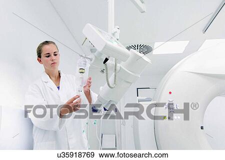 Female doctor checking ct scanner View Large Photo Image Stock Photo - Female doctor checking ct scanner. Fotosearch