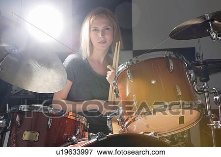 Female drummer sitting behind drums View Large Photo Image Stock Photo - Female drummer sitting behind drums. Fotosearch