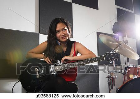 Stock Photography - Female guitarist with electric guitar. Fotosearch