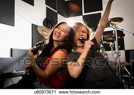 Stock Image - Female music band performing. Fotosearch