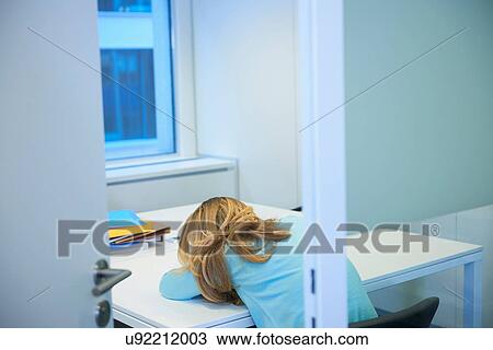 Female office worker asleep at desk View Large Photo Image Stock Image - Female office worker asleep at desk. Fotosearch