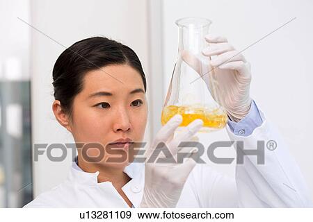 Female scientist examining bacterial growth in flask containing LB (Lysogeny broth) medium View Large Photo Image Stock Photo - Female scientist examining bacterial growth in flask containing LB (Lysogeny broth) medium. Fotosearch