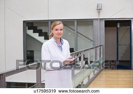 Female scientist in atrium with clipboard View Large Photo Image Stock Photo - Female scientist in atrium with clipboard. Fotosearch