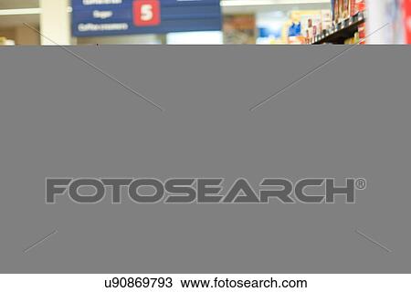 Female shop assistant guiding male customer View Large Photo Image Stock Image - Female shop assistant guiding male customer. Fotosearch