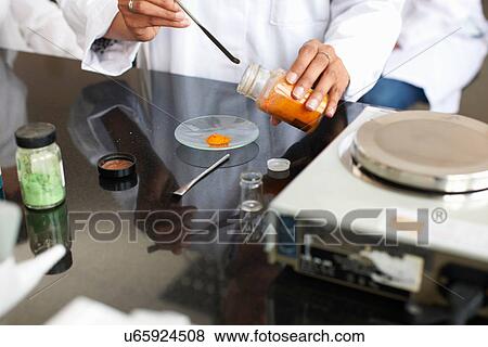 Female technician weighing chemicals in laboratory View Large Photo Image Stock Photo - Female technician weighing chemicals in laboratory. Fotosearch