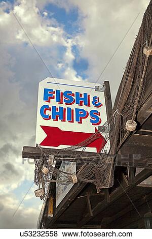Fish and Chips sign outside wooden building View Large Photo Image Stock Photo - Fish and Chips sign outside wooden building. Fotosearch
