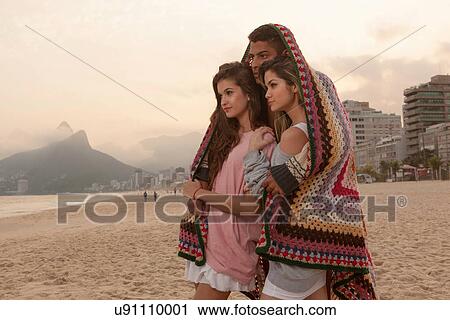 Friends wrapped in blanket, Ipanema Beach, Rio de Janeiro, Brazil View Large Photo Image Stock Image - Friends wrapped in blanket, Ipanema Beach, Rio de Janeiro, Brazil. Fotosearch