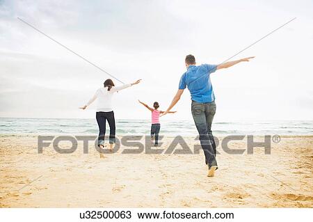 Girl and parents running with arms open View Large Photo Image Stock Image - Girl and parents running with arms open. Fotosearch