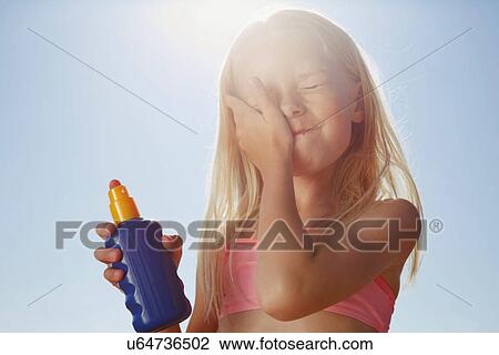 Girl applying sunblock on face View Large Photo Image Stock Image - Girl applying sunblock on face. Fotosearch
