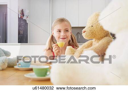 Girl having tea party with soft toys View Large Photo Image Stock Image - Girl having tea party with soft toys. Fotosearch