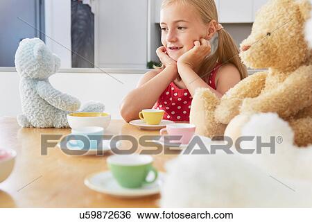 Girl having tea party with soft toys View Large Photo Image Stock Photograph - Girl having tea party with soft toys. Fotosearch