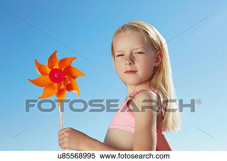 Stock Photography - Girl holding toy windmill. Fotosearch