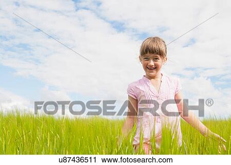 Girl in a field View Large Photo Image Stock Image - Girl in a field. Fotosearch
