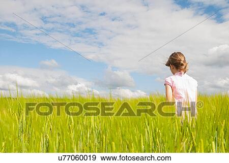 Girl in field View Large Photo Image Stock Photo - Girl in field. Fotosearch