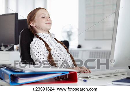 Girl leaning back in office chair View Large Photo Image Picture - Girl leaning back in office chair. Fotosearch