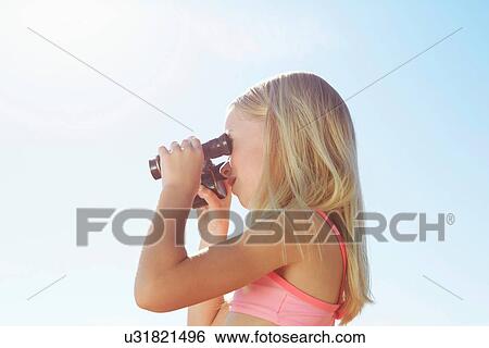 Stock Photograph - Girl looking through binoculars. Fotosearch