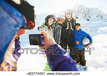 Girl photographing family, Les Arcs, Haute-Savoie, France View Large Photo Image Stock Image - Girl photographing family, Les Arcs, Haute-Savoie, France. Fotosearch