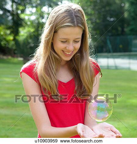 Girl playing with bubble View Large Photo Image Stock Photo - Girl playing with bubble. Fotosearch