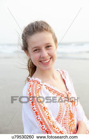 Stock Image - Girl posing for camera on beach. Fotosearch