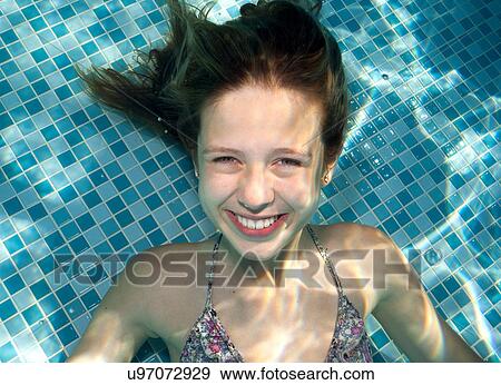 Stock Photo - Girl underwater in swimming pool. Fotosearch