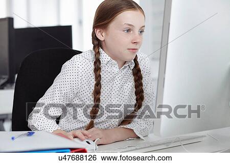Girl using computer in office View Large Photo Image Stock Photograph - Girl using computer in office. Fotosearch