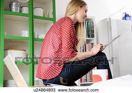 Stock Image - Girl using digital tablet. Fotosearch