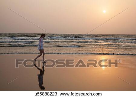 Girl walking on beach View Large Photo Image Stock Image - Girl walking on beach. Fotosearch