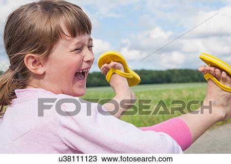 Girl wearing flip flops laughing View Large Photo Image Stock Image - Girl wearing flip flops laughing. Fotosearch