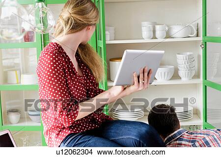 Girl with digital tablet looking sideways View Large Photo Image Picture - Girl with digital tablet looking sideways. Fotosearch
