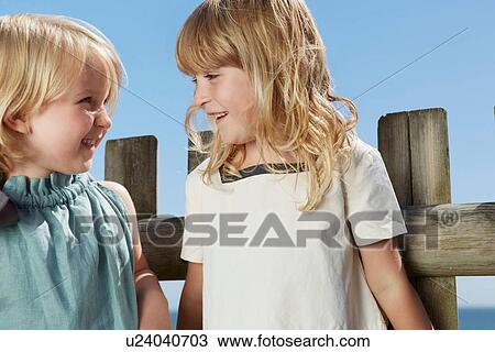 Stock Image - Girls talking. Fotosearch