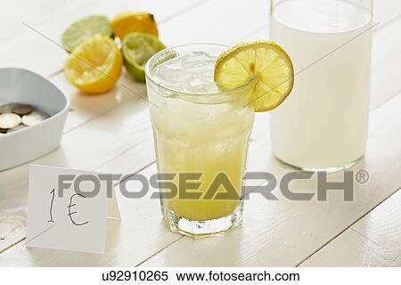 Glass of homemade lemonade with slice of lemon with 1 Euro sign View Large Photo Image Stock Photography - Glass of homemade lemonade with slice of lemon with 1 Euro sign. Fotosearch