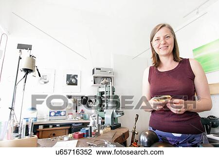 Goldsmith holding gold piece View Large Photo Image Stock Image - Goldsmith holding gold piece. Fotosearch